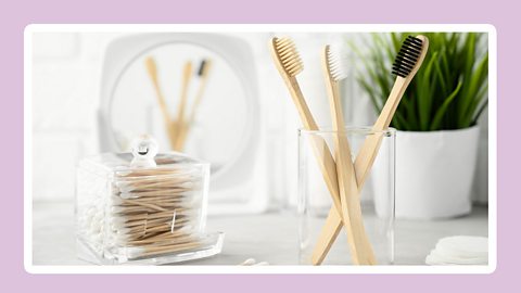 Five toothbrushes made from bamboo in a glass. 