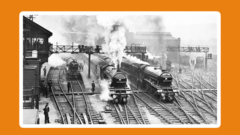 A photograph of steam engines leaving King's Cross Station, about 1930.