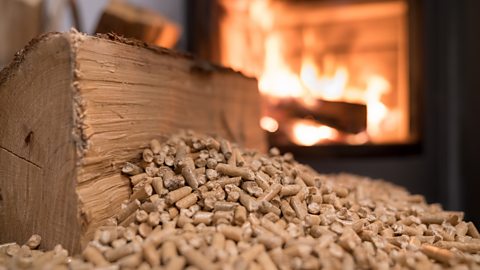 Photograph showing wood pellets in front of a wood pellet boiler.