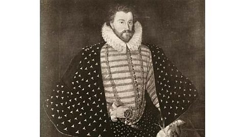 A black and white portrait of Christopher Hatton, who is wearing a spotted cloak and a ruff around his neck.