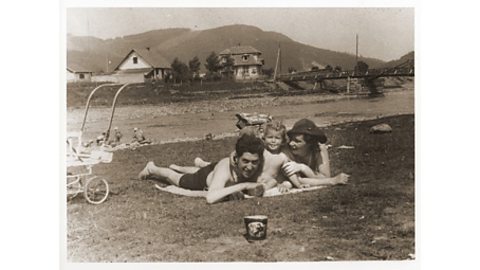 A black and white photograph of a Jewish family on the beach in Poland.