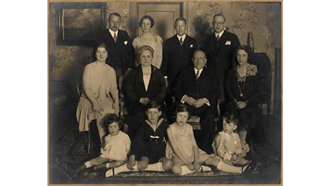 A black and white family portrait taken at a birthday party.