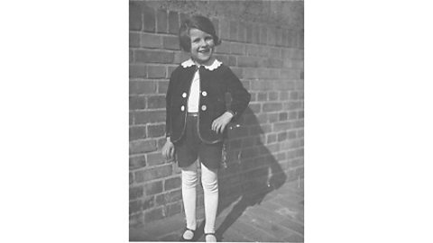 A black and white photograph of a young girl in a costume for her school play.