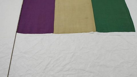 A purple, white and green Suffragette flag.