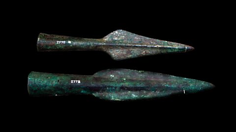 Two pointed metal spearheads.