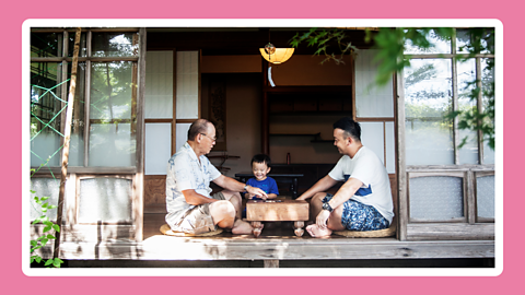 A photo of three family generations playing a game.