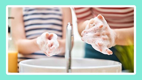 Two children washing their hands