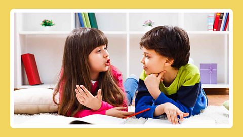 Two children talking and listening to each other. 