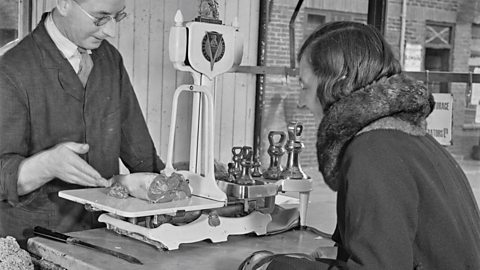 A butcher selling meat.