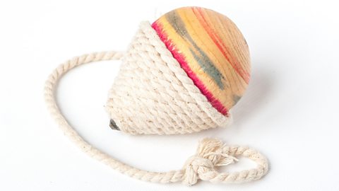 A spinning top made of wood and rope.