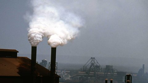 Smoke billowing from a factory chimney