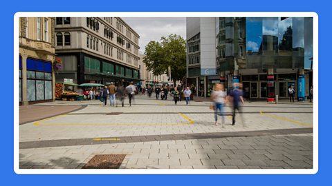 People walking along a high street in Cardiff.