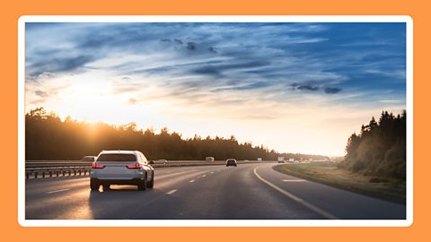 Cars driving on a dual carriageway.