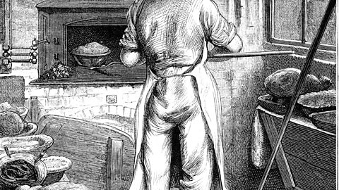 A baker baking bread.