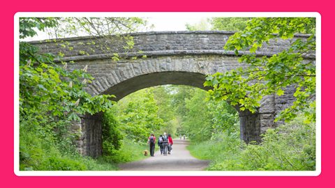 People walking along the Monsal Trail, an old railway in the Peak District