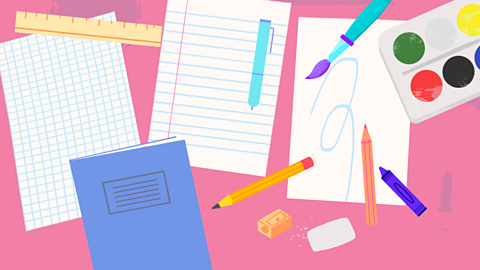 Birds-eye view of desk with paper, jotter and stationary on it