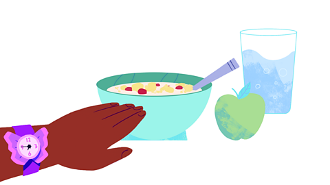 A bowl of cereal, apple and glass of water. An arm reaches, wearing a watch saying 7:45am