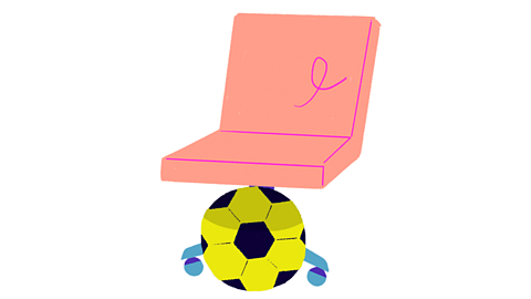 The football is under the chair.