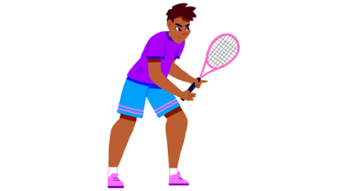 A boy playing tennis.