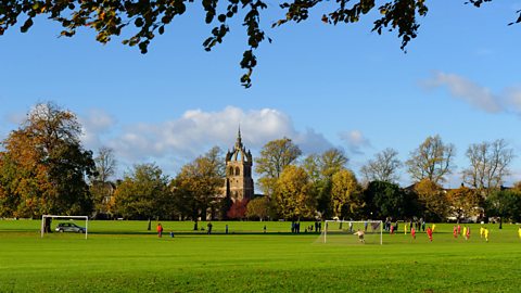 Young people playing football in South Inch Park in Perth 