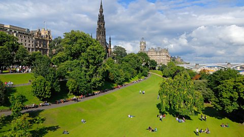 People sitting in Princes Street Gardens in Edinburgh 