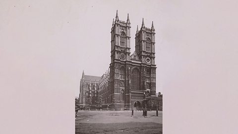 A black and white illustration of the front facade of Westminster Abbey 