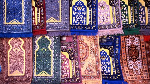 Intricately decorated hanging prayer rugs