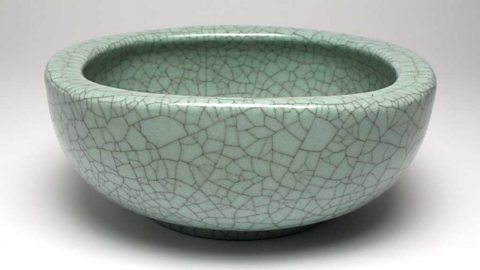 Closeup of a bowl. Light green with decorative cracks