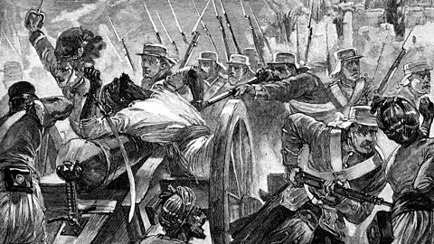 A black and white etching of British soldiers pointing guns at Indian rebels who are in possession of a canon, the rebels are outnumbered