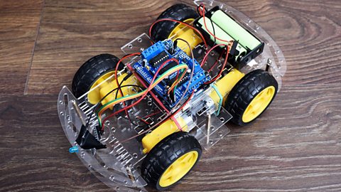 A toy car with an electrical circuit in it. Is has batteries and an LED at the front.