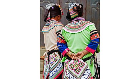 Women in colourful traditional clothing and hats