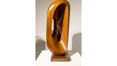 A gallery display of one of Barbara's wooden sculptures called 'Fugue'