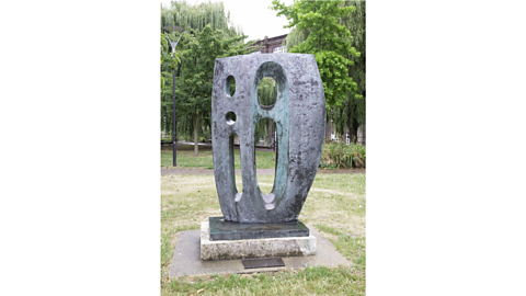 An outdoor display of one of Barbara's bronze sculptures with several holes called 'Sea Form (Atlantic)'