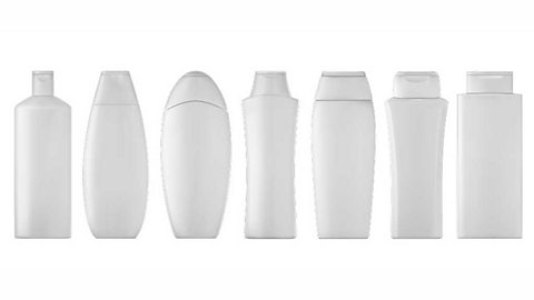 7 blank white shampoo bottles of different shapes