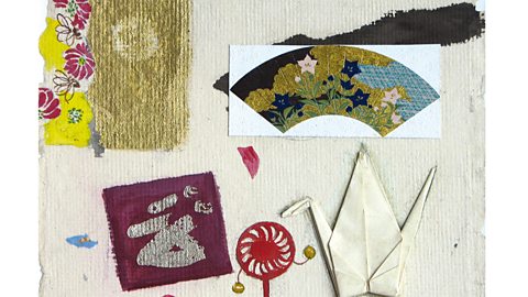 A collage with a rattle, a fan, an origami crane and some painted Japanese letters