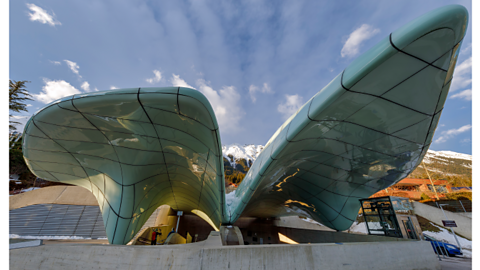 A blue building, made of two big curves.