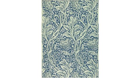 A floral pattern printed in a greyish blue on top of a cream background