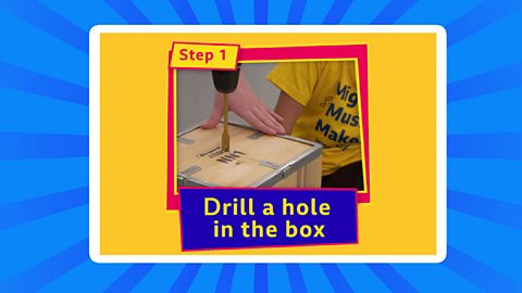 Drilling a hole into a wooden box.