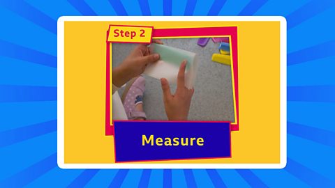 A child measuring paper