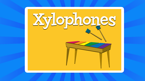 An illustrated image of a colourful xylophone and it's beaters.