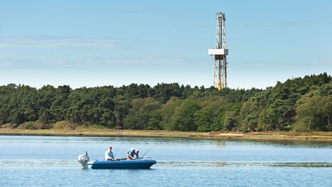Poole Harbour with oil drilling rig and fishing boat