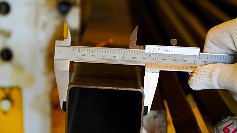 Mechanic uses vernier to measure the size of the mild steel box section