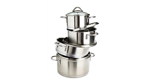 Tower of stainless steel saucepans