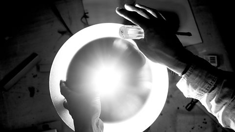 Photo of artist taken from below holding critical assembly (Credit: Ben Platts-Mills)