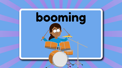 The word booming above a drummer banging the drums.