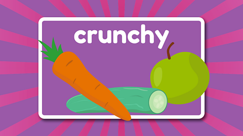 The word crunchy above an apple, carrot and cucumber.