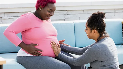 Latino doula with pregnant woman