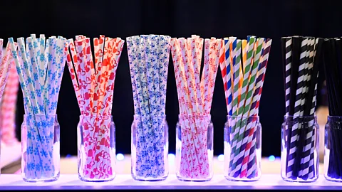 A selection of multi-coloured straws in jars (Credit: Getty Images)