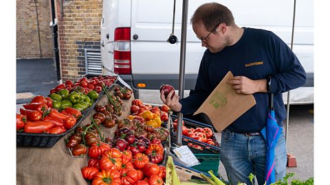 Getty Images A man shops for tomatoes at a market in London. The UK imports around 95% of its tomatoes (Credit: Getty Images)