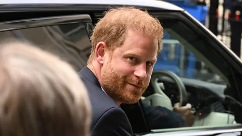 A picture of Prince Harry getting into a car